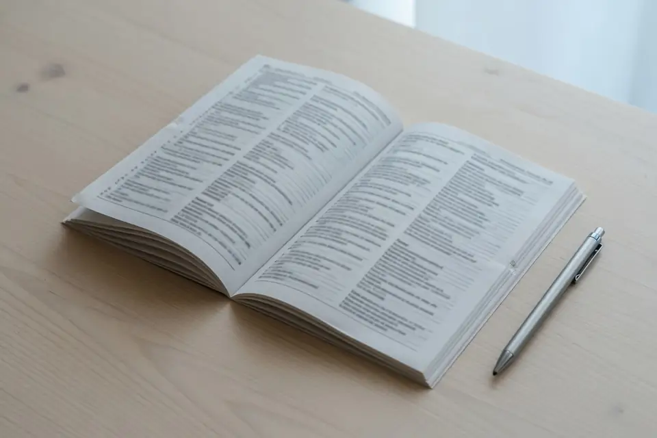 A printed community rules packet on a wooden table